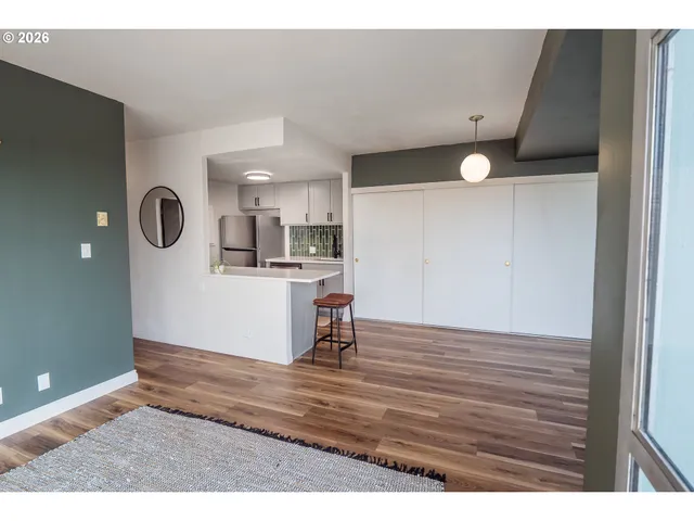 a view of empty room with wooden floor