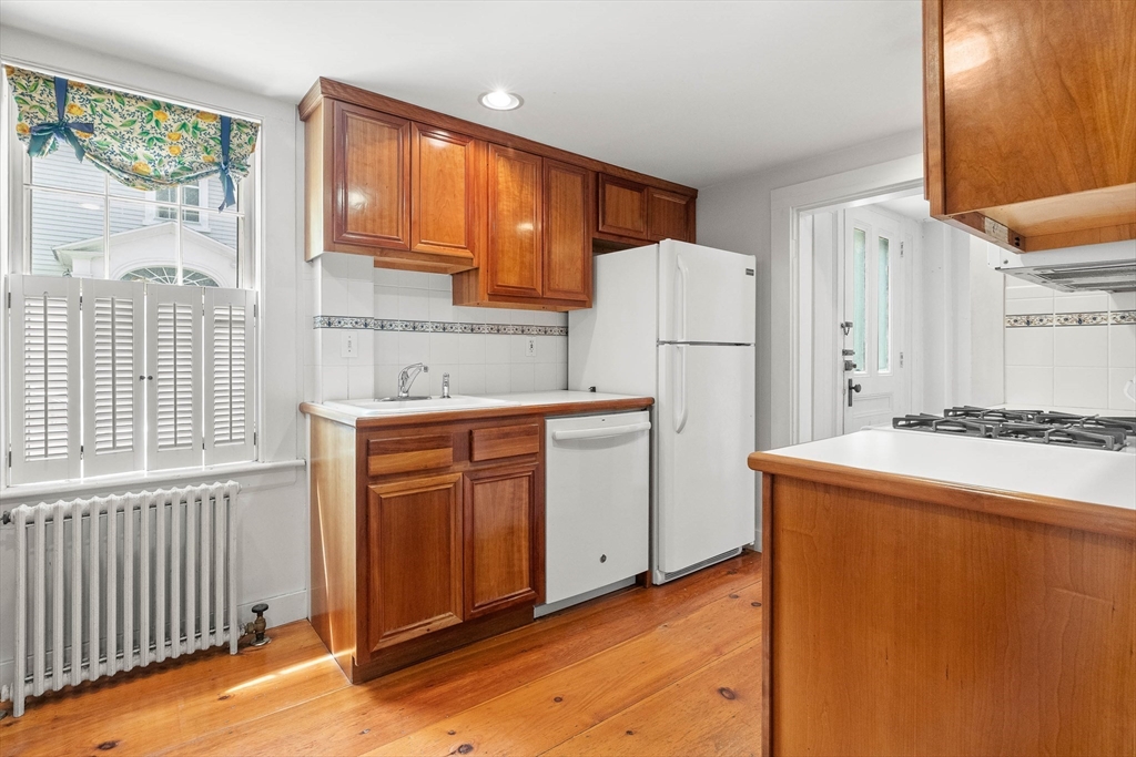 2 High Street Marblehead, MA 01945 - Photo 12 of 35 a kitchen with a refrigerator a stove top oven and a large window