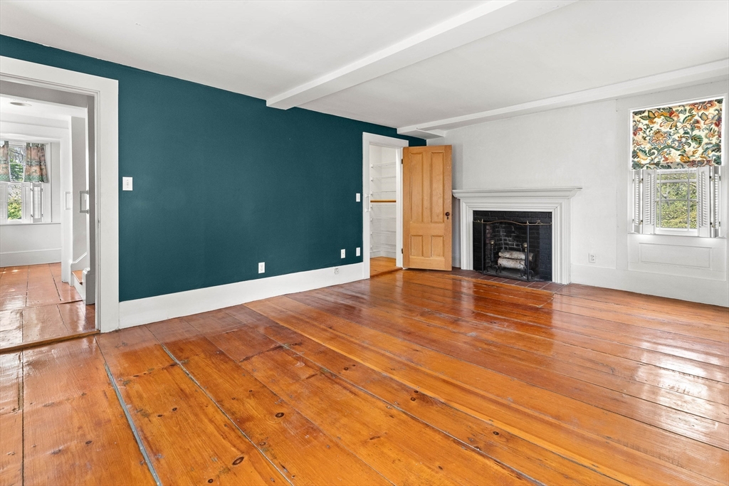 2 High Street Marblehead, MA 01945 - Photo 17 of 35 a view of empty room with wooden floor and fireplace