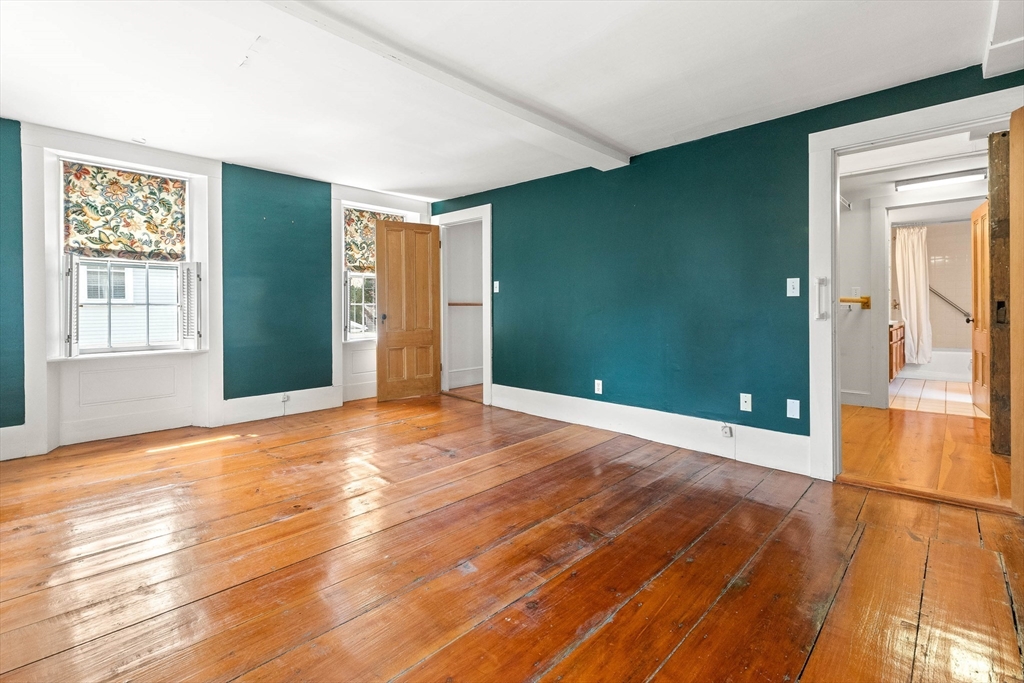 2 High Street Marblehead, MA 01945 - Photo 18 of 35 an empty room with wooden floor and windows