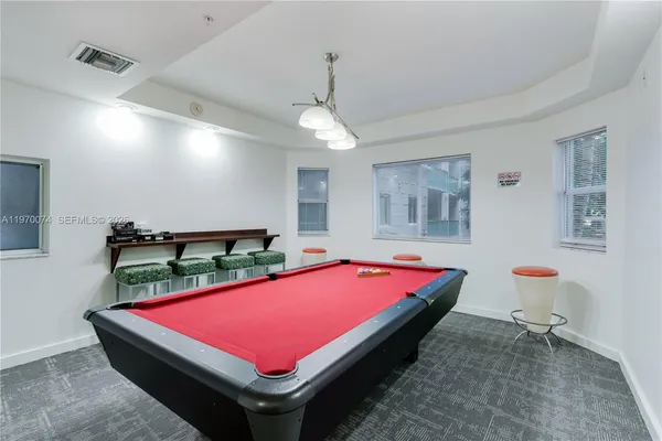 a room with pool table and flat screen tv
