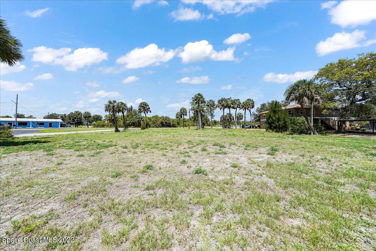 a view of a green field with wooden fence