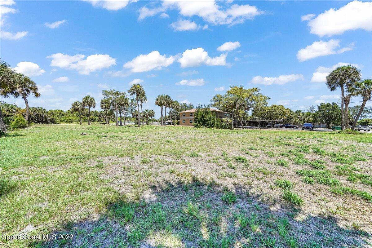204 West Ave B Melbourne, FL 32901 - Photo 4 of 9 a view of a grassy field with trees in the background