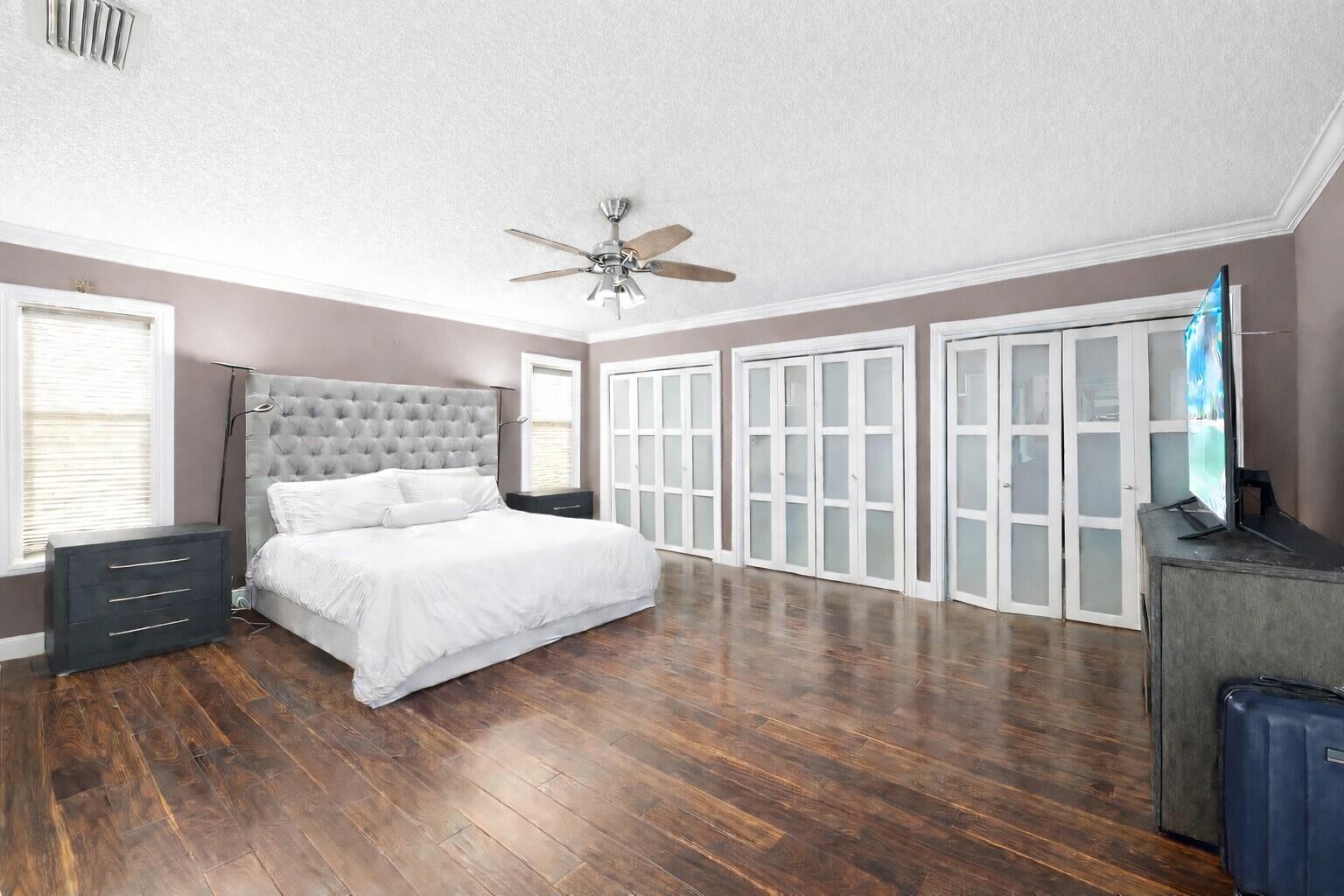 5701 Southwest 136th Street Miami, FL 33156 - Photo 12 of 25 a bedroom with a large bed and a flat tv screen on dresser