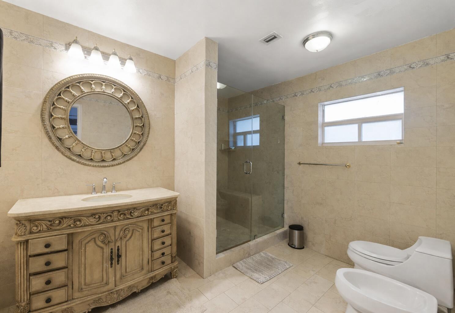 5701 Southwest 136th Street Miami, FL 33156 - Photo 14 of 25 a bathroom with a sink mirror vanity and toilet