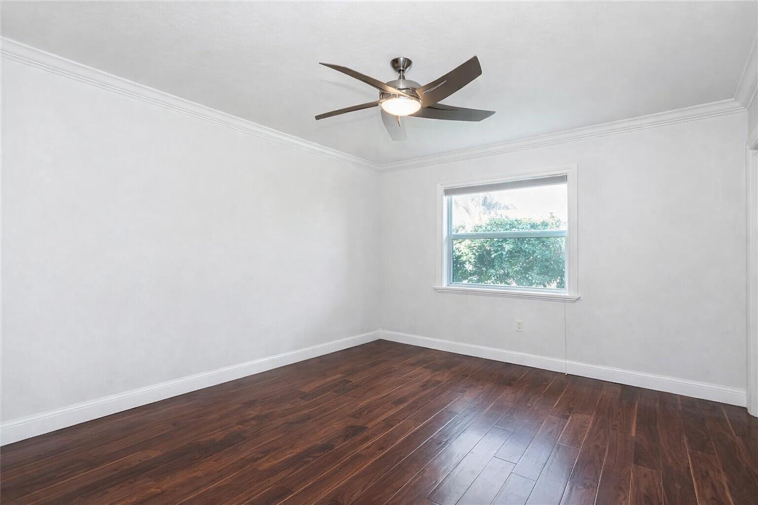 5701 Southwest 136th Street Miami, FL 33156 - Photo 19 of 25 wooden floor in an empty room with a window