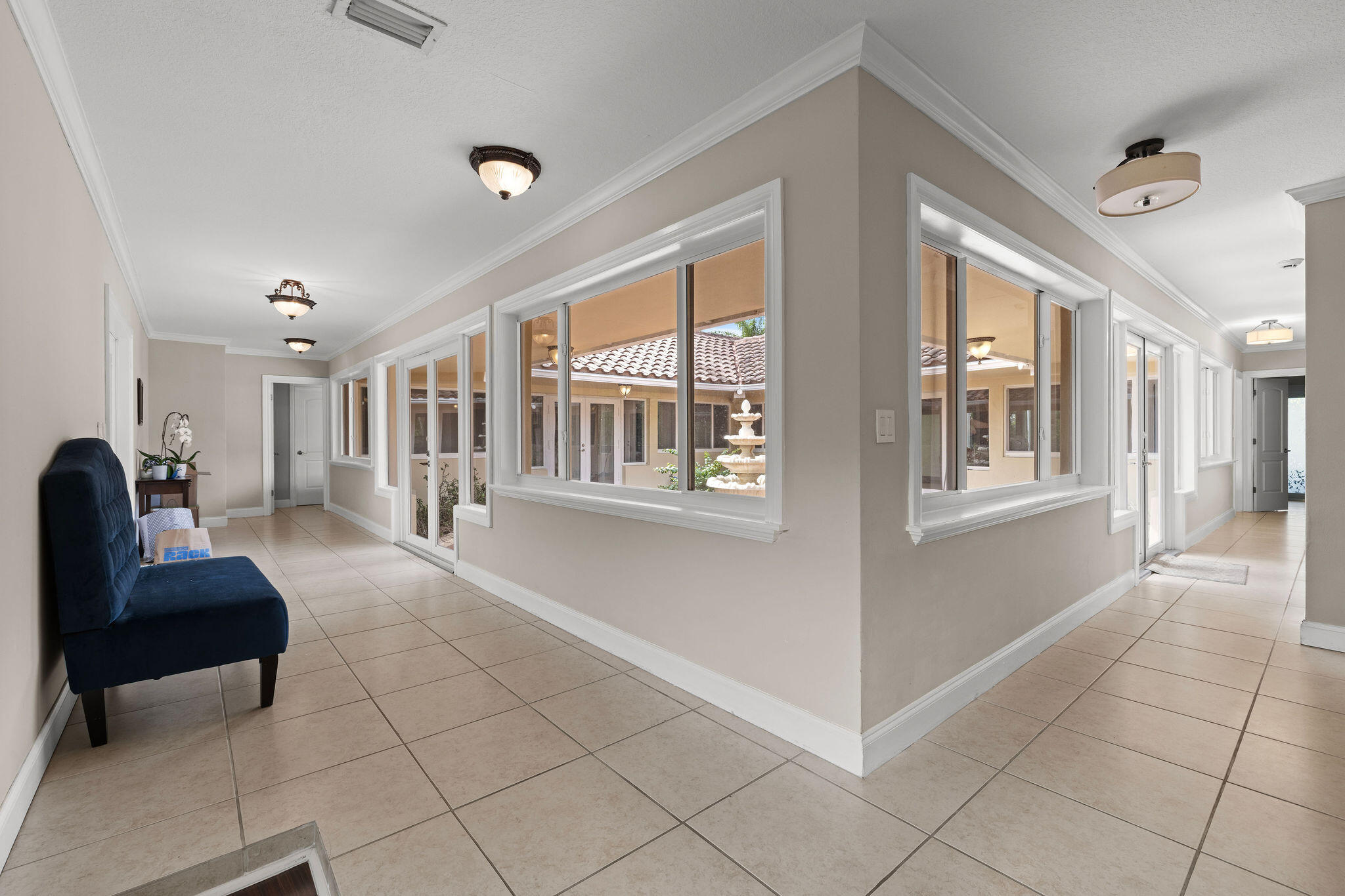 5701 Southwest 136th Street Miami, FL 33156 - Photo 20 of 25 a living room with couches and a large window with kitchen view