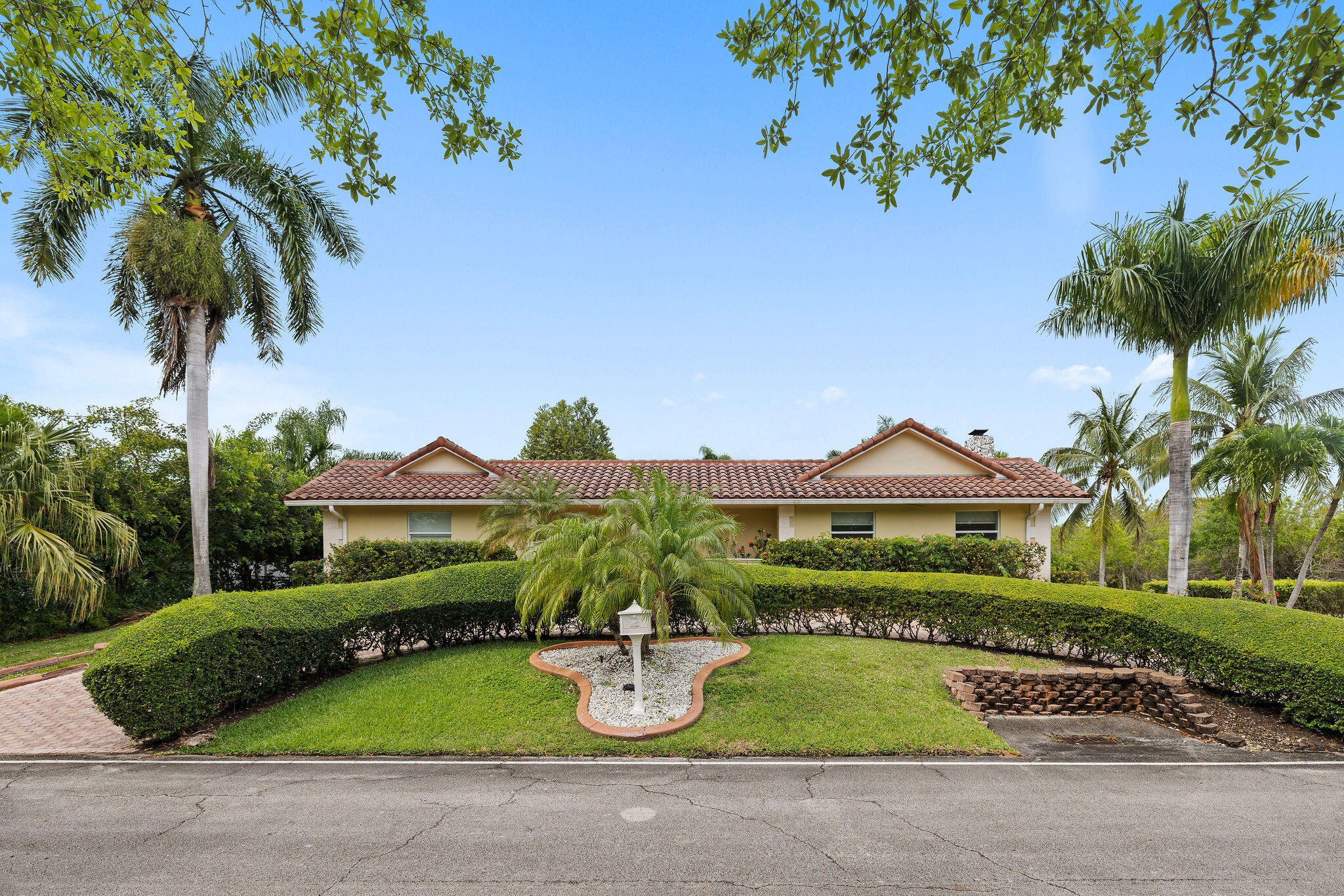 5701 Southwest 136th Street Miami, FL 33156 - Photo 2 of 25 a front view of a house with garden