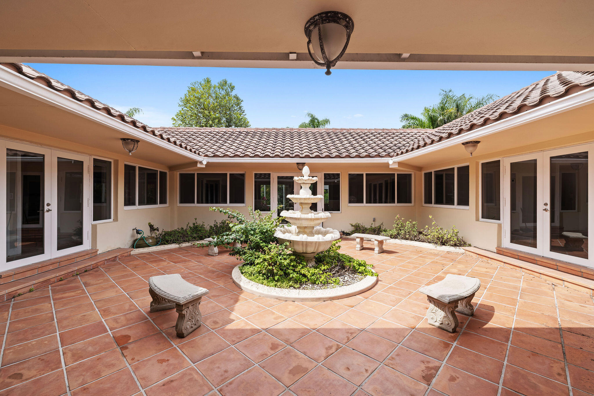 5701 Southwest 136th Street Miami, FL 33156 - Photo 21 of 25 a front view of a house with swimming pool fire pit and outdoor seating