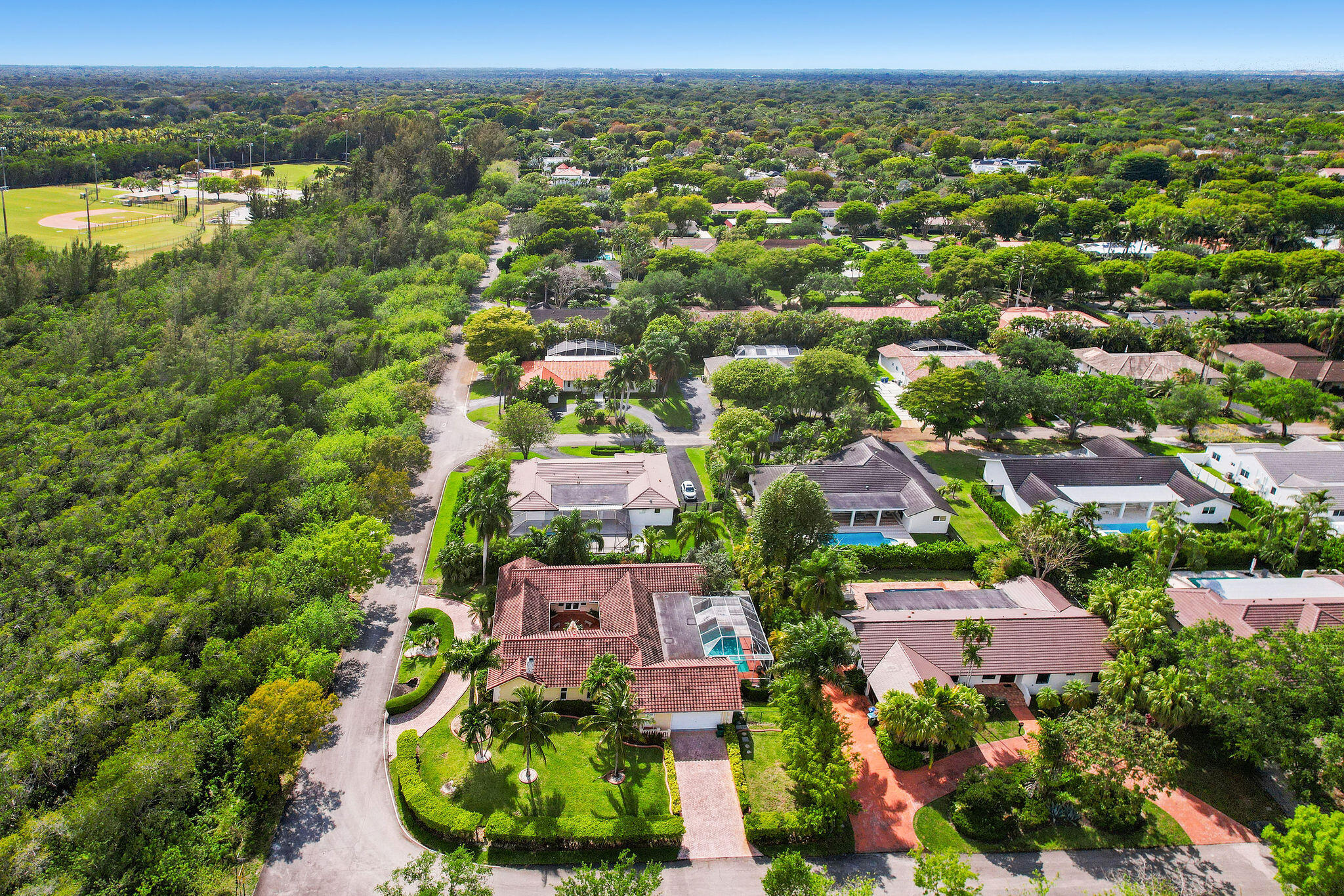 5701 Southwest 136th Street Miami, FL 33156 - Photo 24 of 25 an aerial view of residential houses with outdoor space and trees