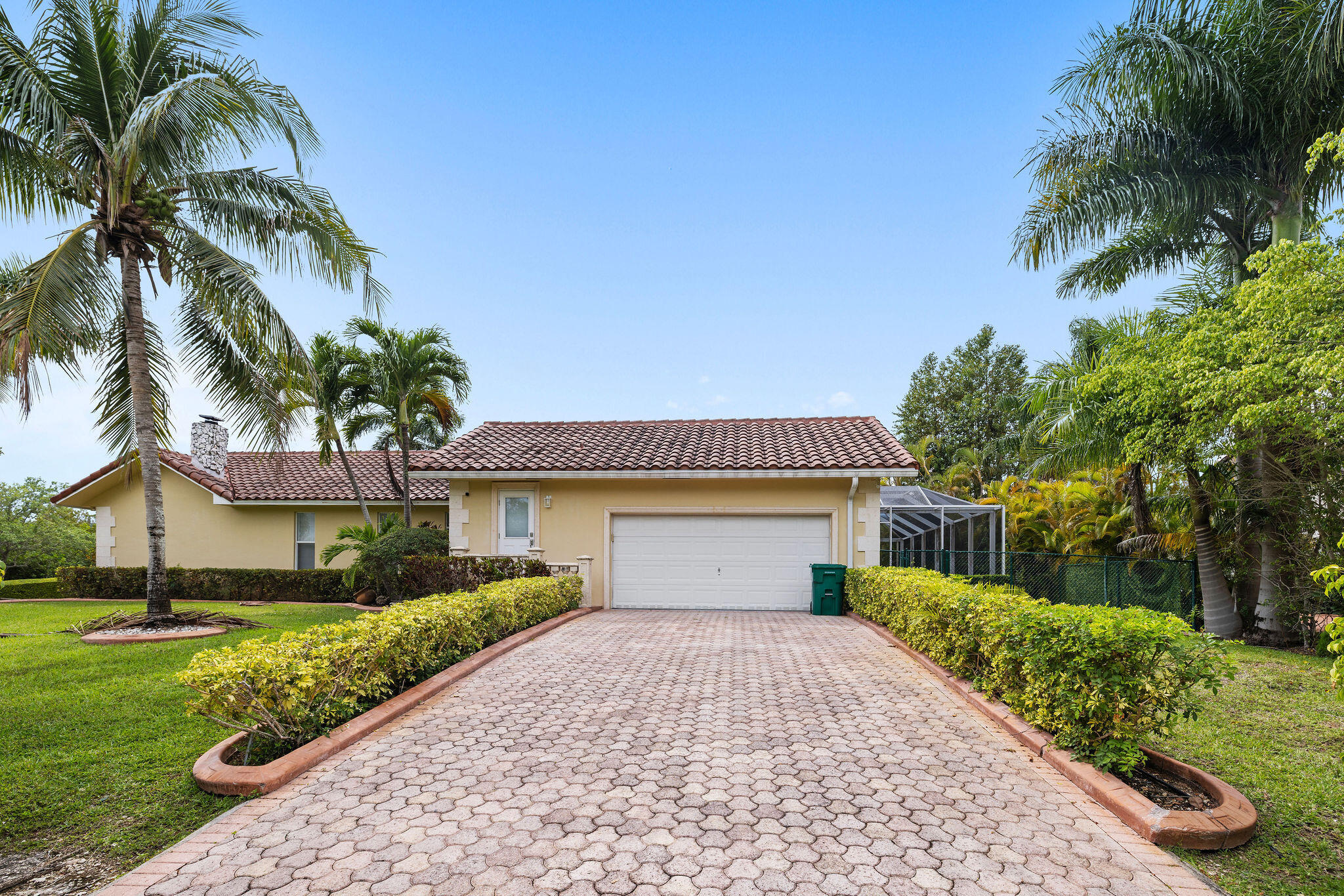 5701 Southwest 136th Street Miami, FL 33156 - Photo 3 of 25 a front view of a house with a yard and potted plants