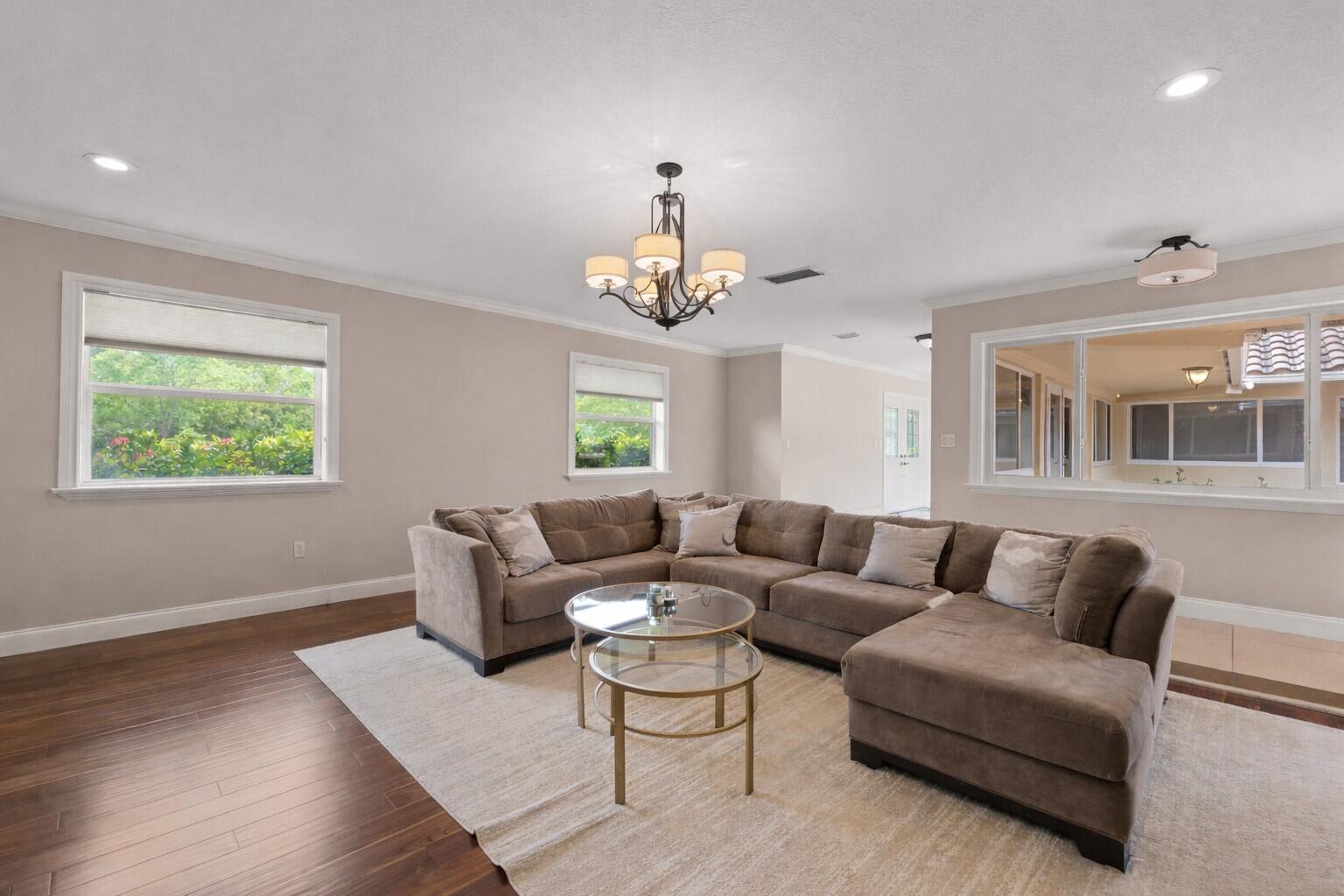 5701 Southwest 136th Street Miami, FL 33156 - Photo 4 of 25 a living room with furniture a chandelier and a window