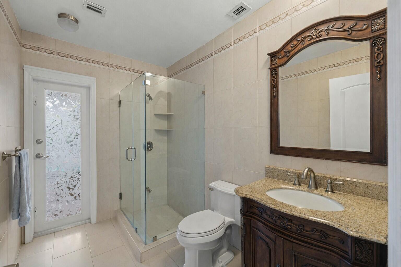 5701 Southwest 136th Street Miami, FL 33156 - Photo 8 of 25 a bathroom with a granite countertop sink toilet and shower