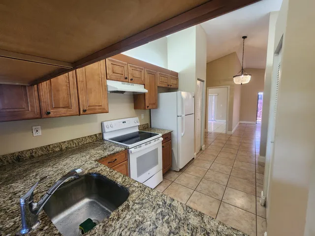 a kitchen with a sink and a mirror