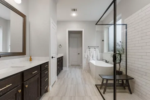 a bathroom with a double vanity sink and a mirror