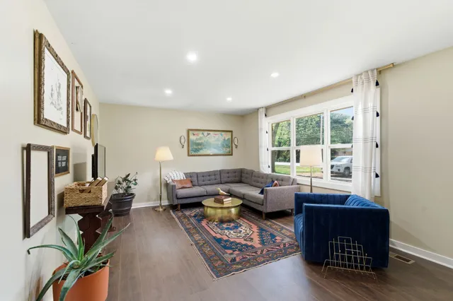 a view of a dining room with furniture and a chandelier fan