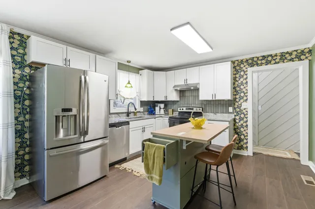 a bedroom with two large bed and a window