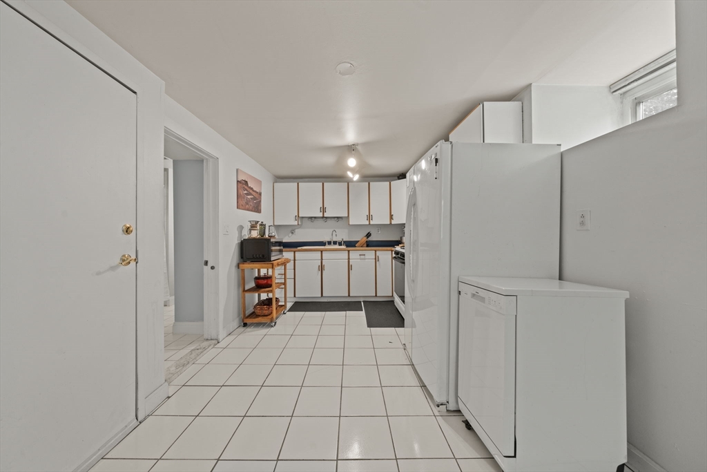 25 Pinedale Road, Unit 1 Boston, MA 02131 - Photo 11 of 21 a kitchen with stainless steel appliances a refrigerator and cabinets