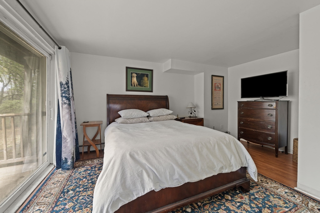 25 Pinedale Road, Unit 1 Boston, MA 02131 - Photo 12 of 21 a bedroom with a bed and a flat screen tv