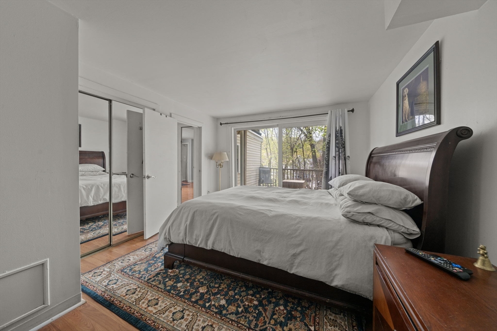 25 Pinedale Road, Unit 1 Boston, MA 02131 - Photo 13 of 21 a bedroom with a bed and glass door