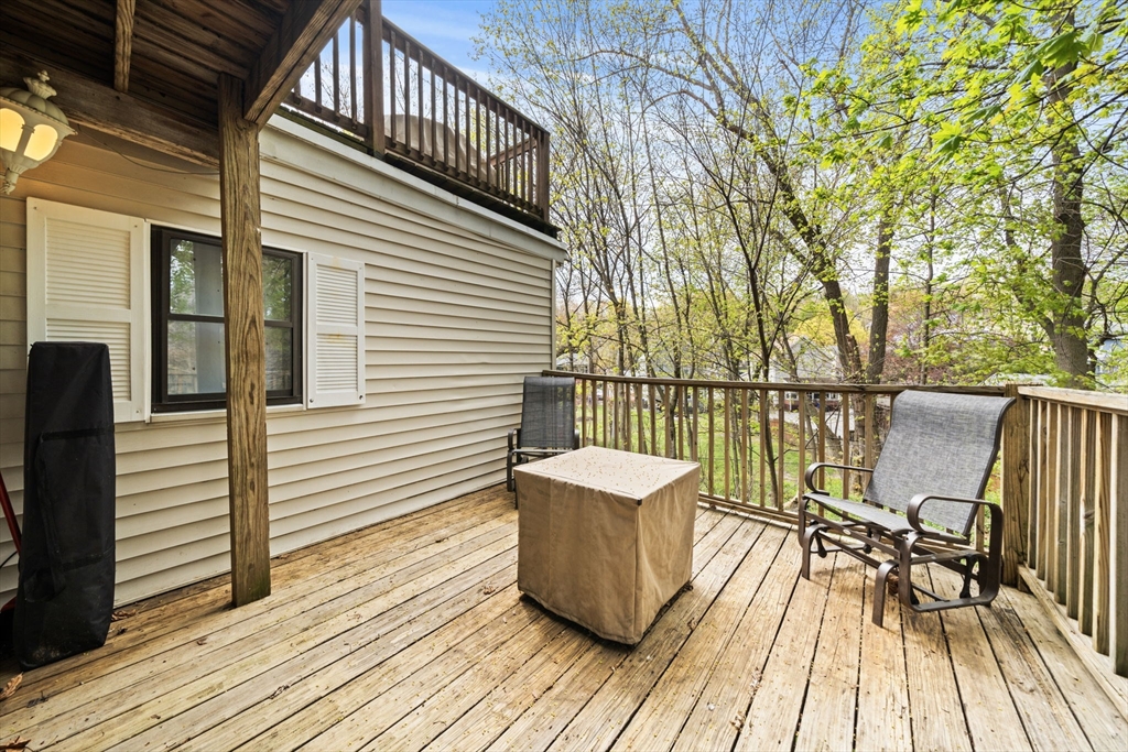 25 Pinedale Road, Unit 1 Boston, MA 02131 - Photo 15 of 21 a view of a balcony with wooden floor and outdoor seating