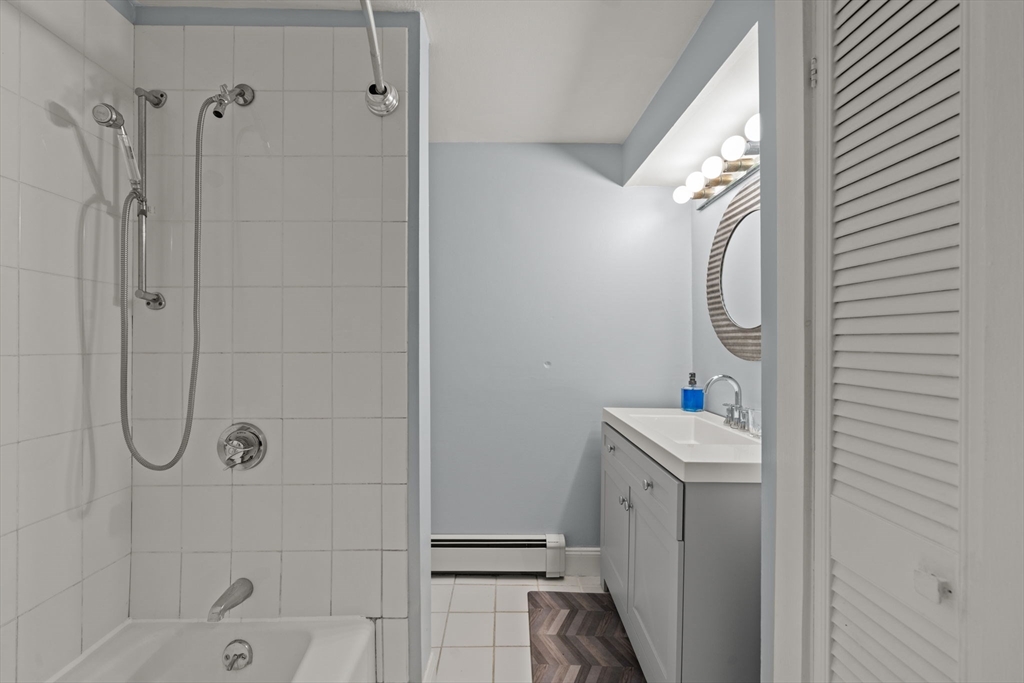 25 Pinedale Road, Unit 1 Boston, MA 02131 - Photo 17 of 21 a bathroom with a sink a vanity and shower