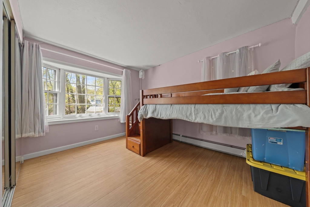 25 Pinedale Road, Unit 1 Boston, MA 02131 - Photo 18 of 21 a bedroom with a bed and a window