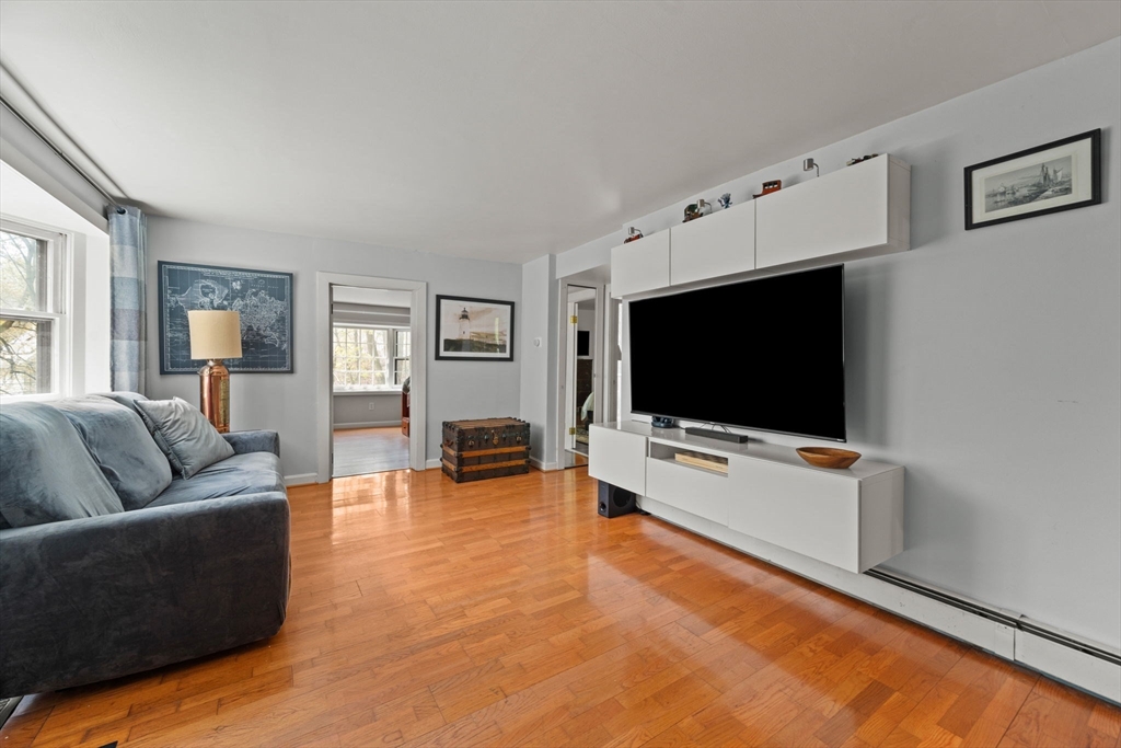 25 Pinedale Road, Unit 1 Boston, MA 02131 - Photo 4 of 21 a living room with furniture and a flat screen tv