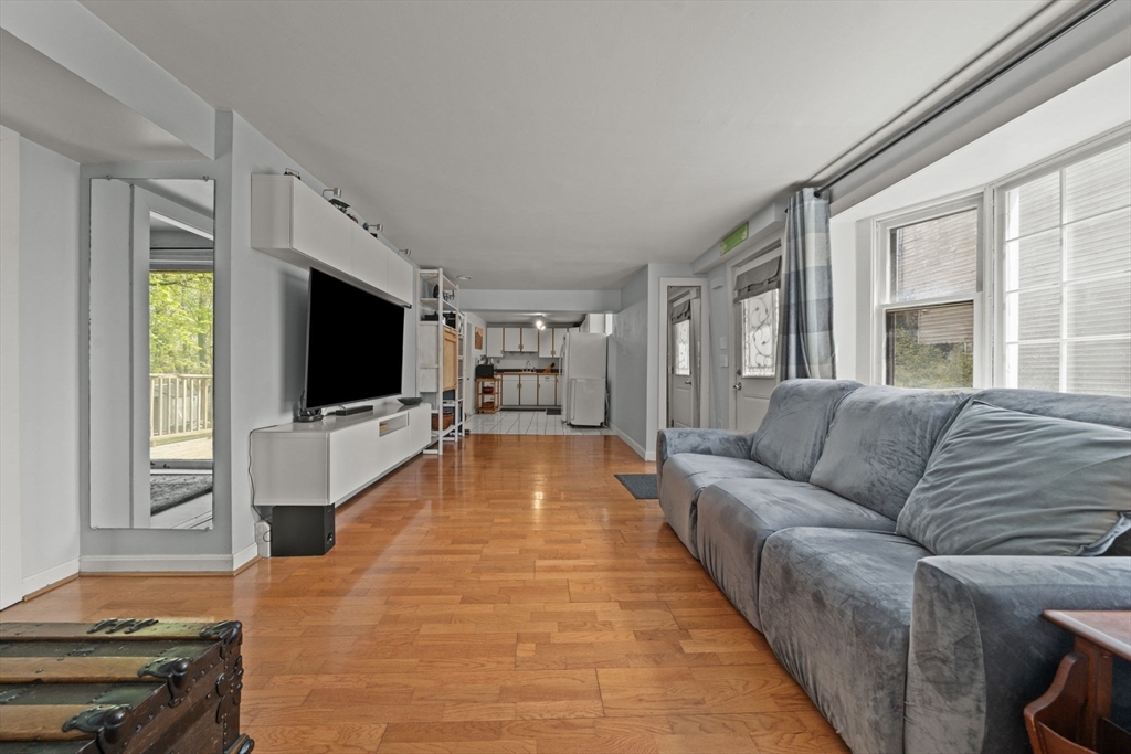 25 Pinedale Road, Unit 1 Boston, MA 02131 - Photo 5 of 21 a living room with furniture and a flat screen tv