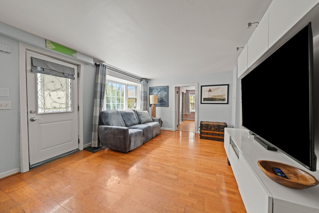 25 Pinedale Road, Unit 1 Boston, MA 02131 - Photo 7 of 21 a living room with furniture and a flat screen tv