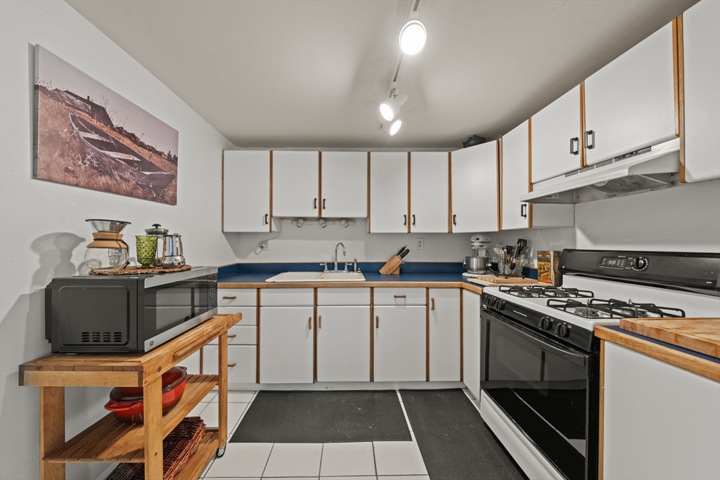 25 Pinedale Road, Unit 1 Boston, MA 02131 - Photo 10 of 21 a kitchen with stainless steel appliances granite countertop a stove and a sink