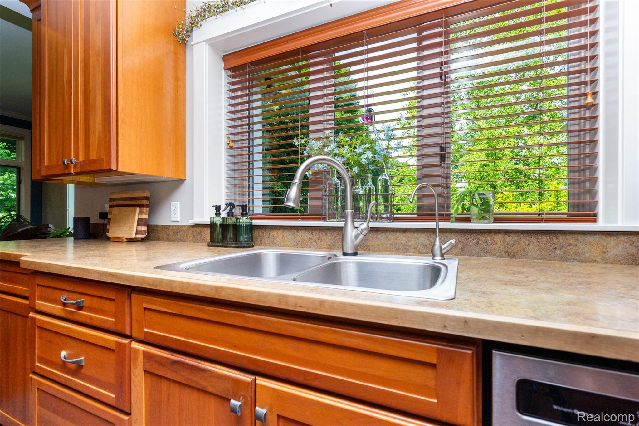 9887 Hadley Road Clarkston, MI 48348 - Photo 11 of 56 Kitchen sink with a dual basin, stainless steel faucet, and a separate water filtration faucet