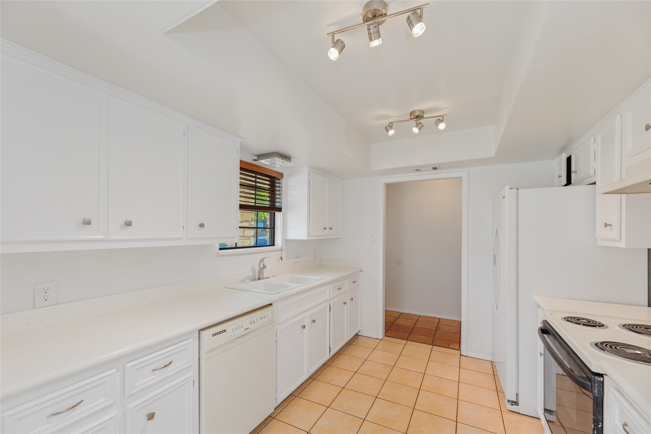 13406 Effingham Street Austin, TX 78729 - Photo 11 of 32 a spacious bathroom with a double vanity sink a mirror and a shower