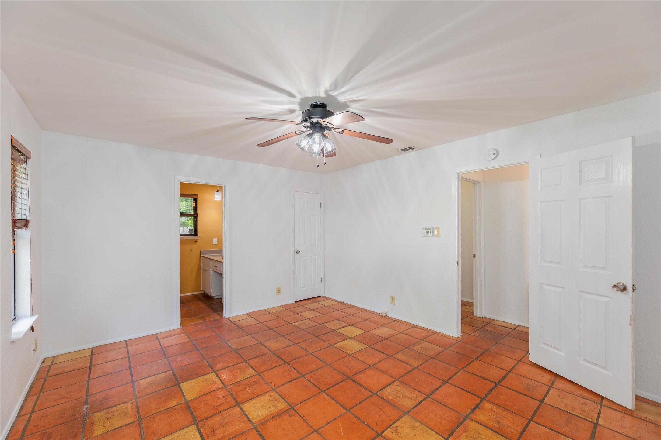 13406 Effingham Street Austin, TX 78729 - Photo 16 of 32 a view of a room with a chandelier fan and a window