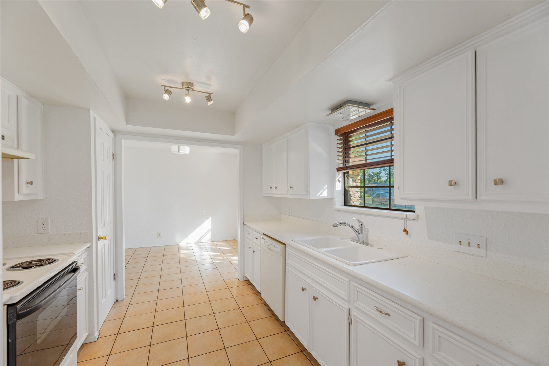 13406 Effingham Street Austin, TX 78729 - Photo 3 of 32 a spacious bathroom with a double vanity sink a mirror and a bathtub