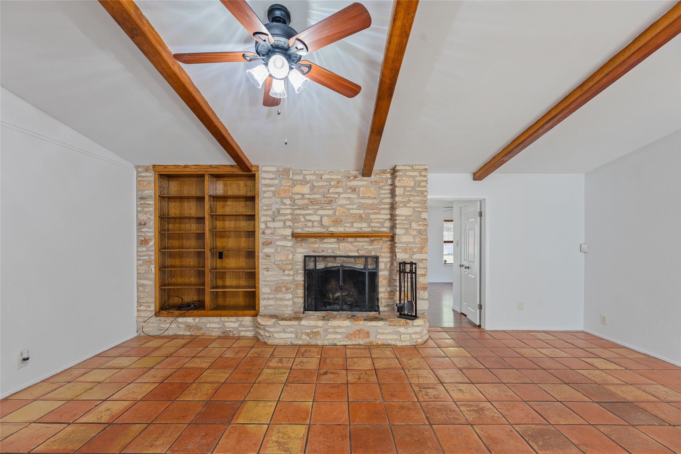 13406 Effingham Street Austin, TX 78729 - Photo 9 of 32 a view of an empty room with chandelier fan and fire place