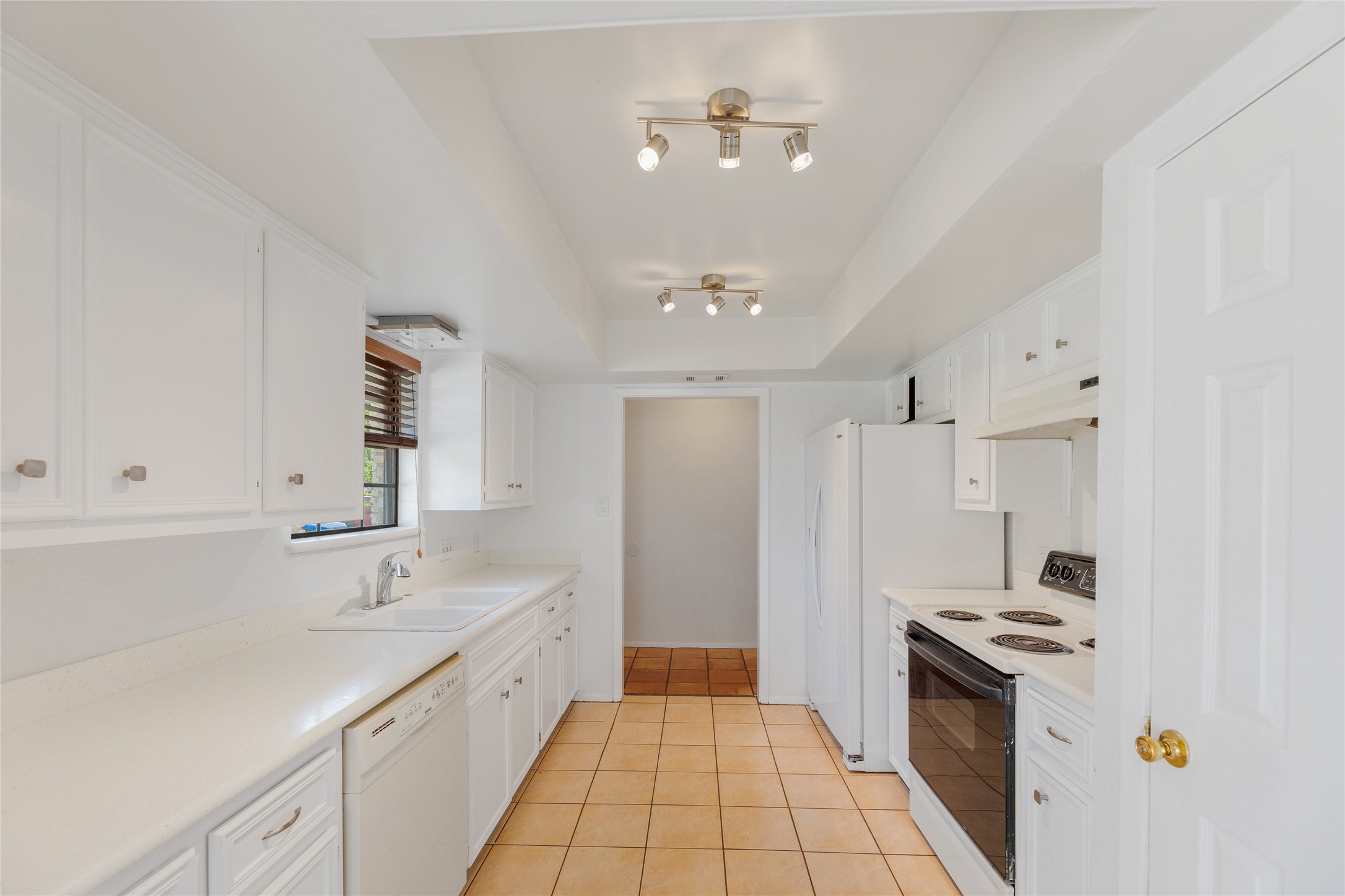 13406 Effingham Street Austin, TX 78729 - Photo 10 of 32 a large kitchen with a stove and a sink