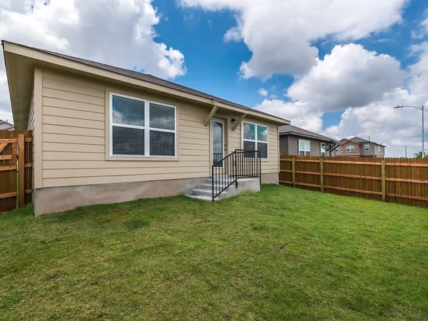 a view of a backyard with plants and a backyard