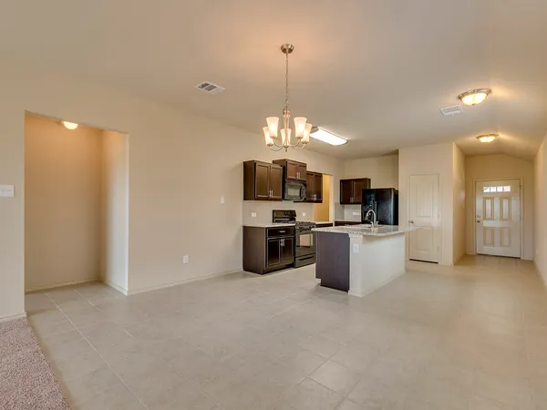 a large kitchen with a sink and counter top space