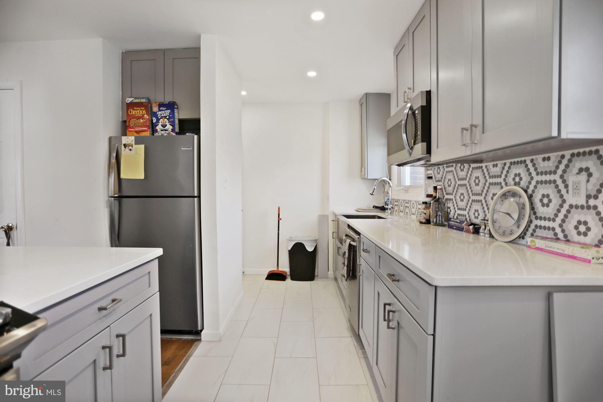 4910 Sargent Road Northeast Washington, DC 20017 - Photo 5 of 16 a kitchen with a sink and a refrigerator