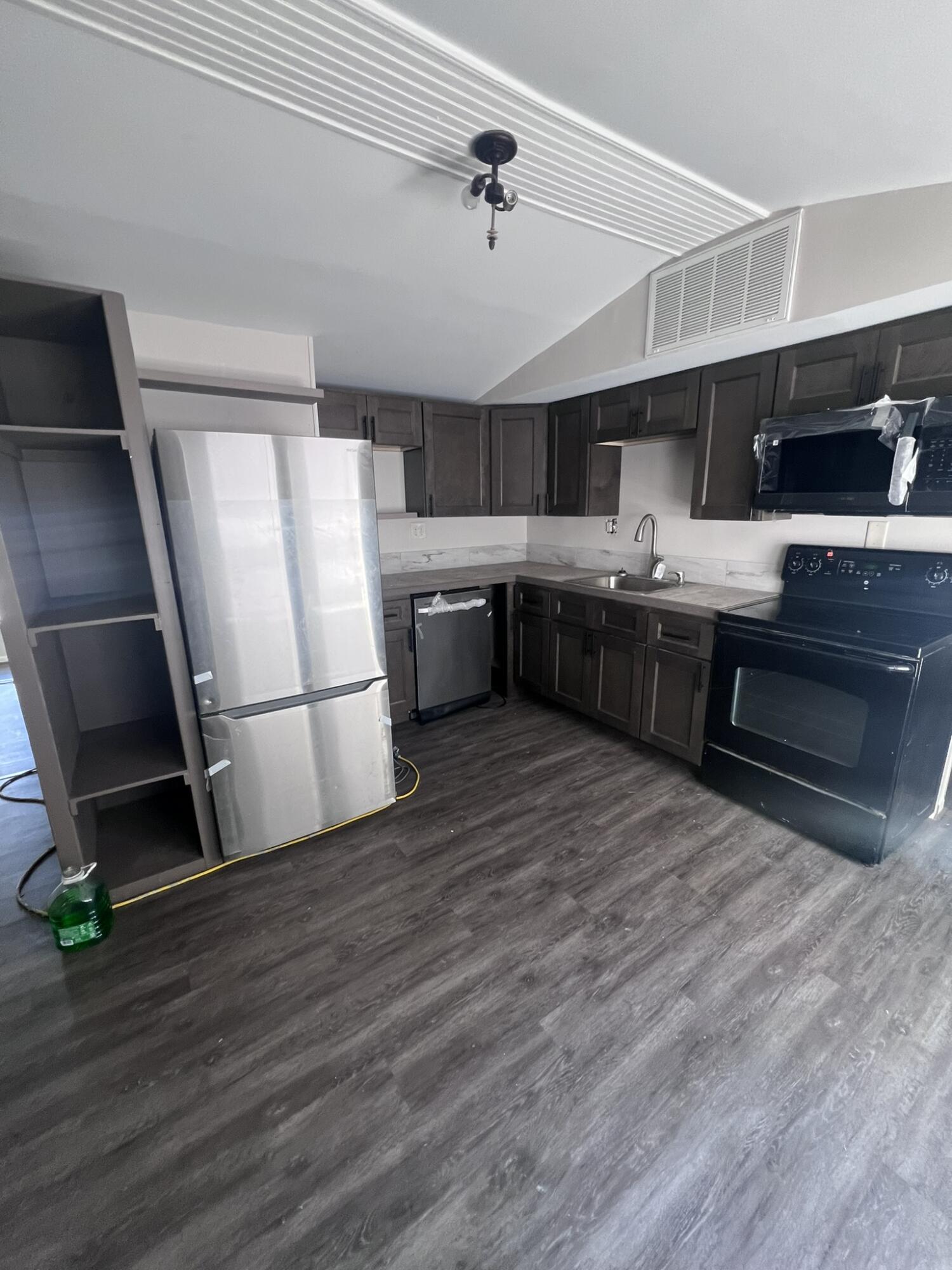 a kitchen with stainless steel appliances a stove a refrigerator and a sink