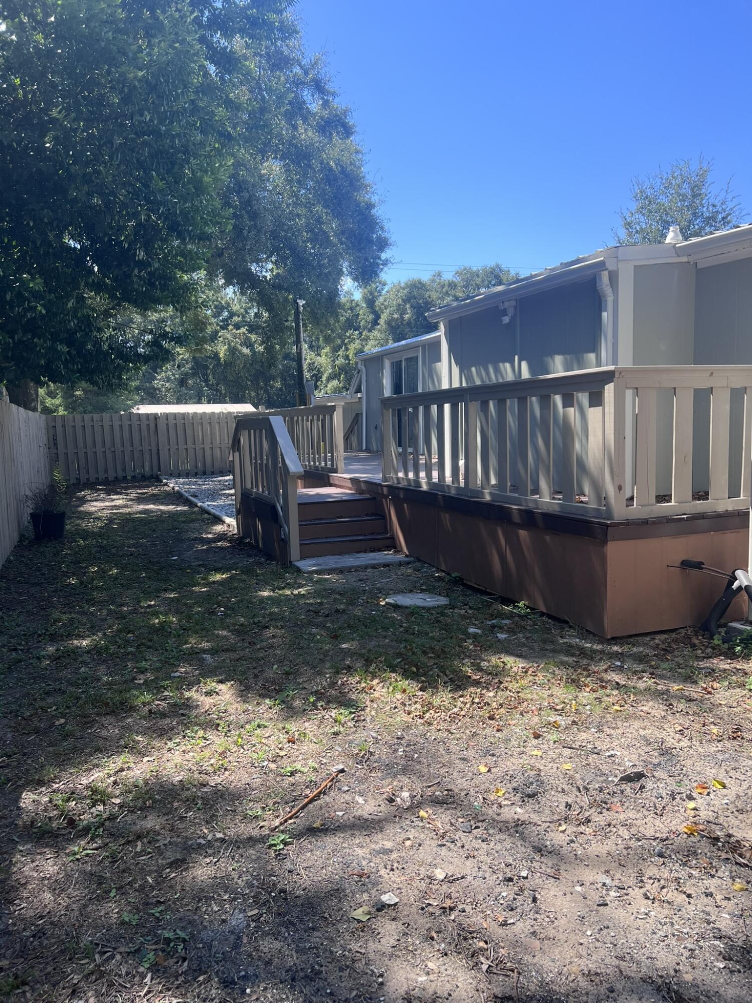 2363 Susan Drive Crestview, FL 32536 - Photo 14 of 16 a view of backyard with deck and wooden fence