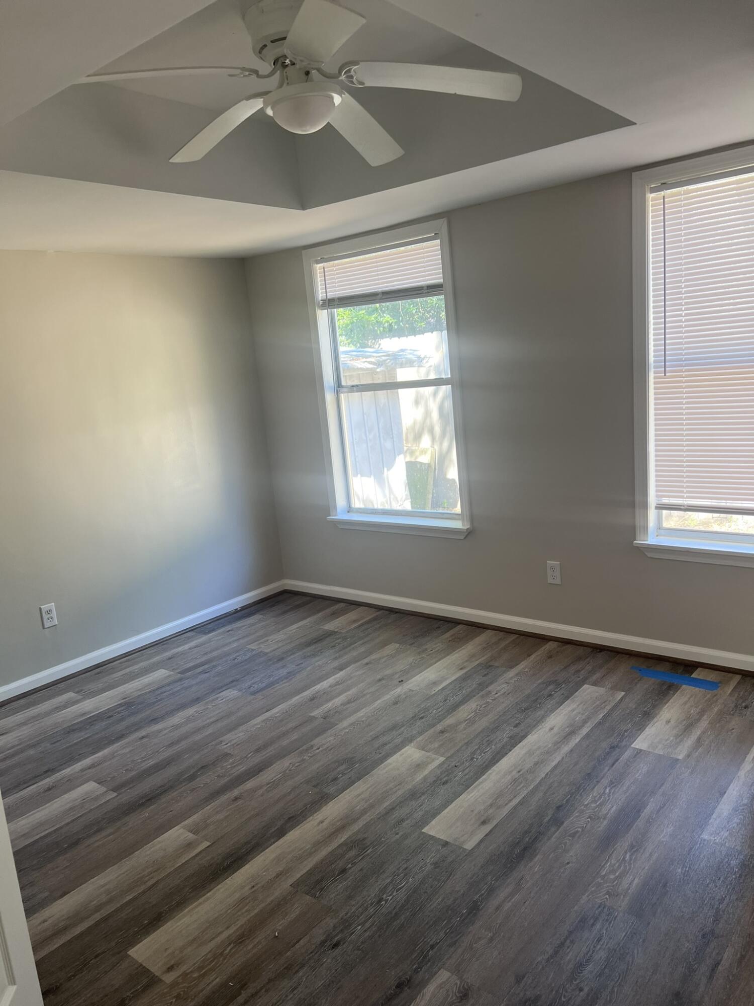 2363 Susan Drive Crestview, FL 32536 - Photo 2 of 16 an empty room with wooden floor windows and fan