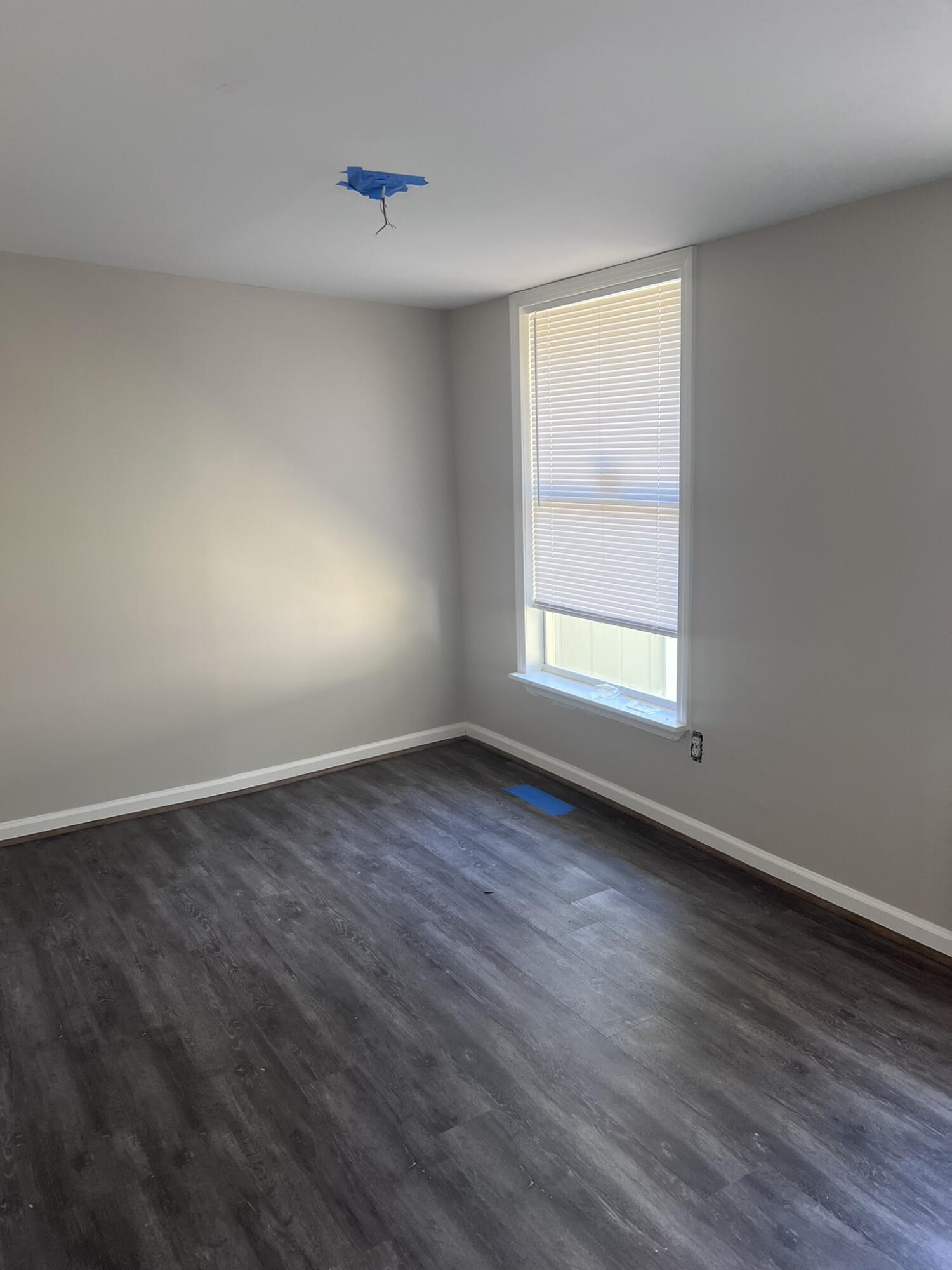 2363 Susan Drive Crestview, FL 32536 - Photo 6 of 16 an empty room with wooden floor and windows