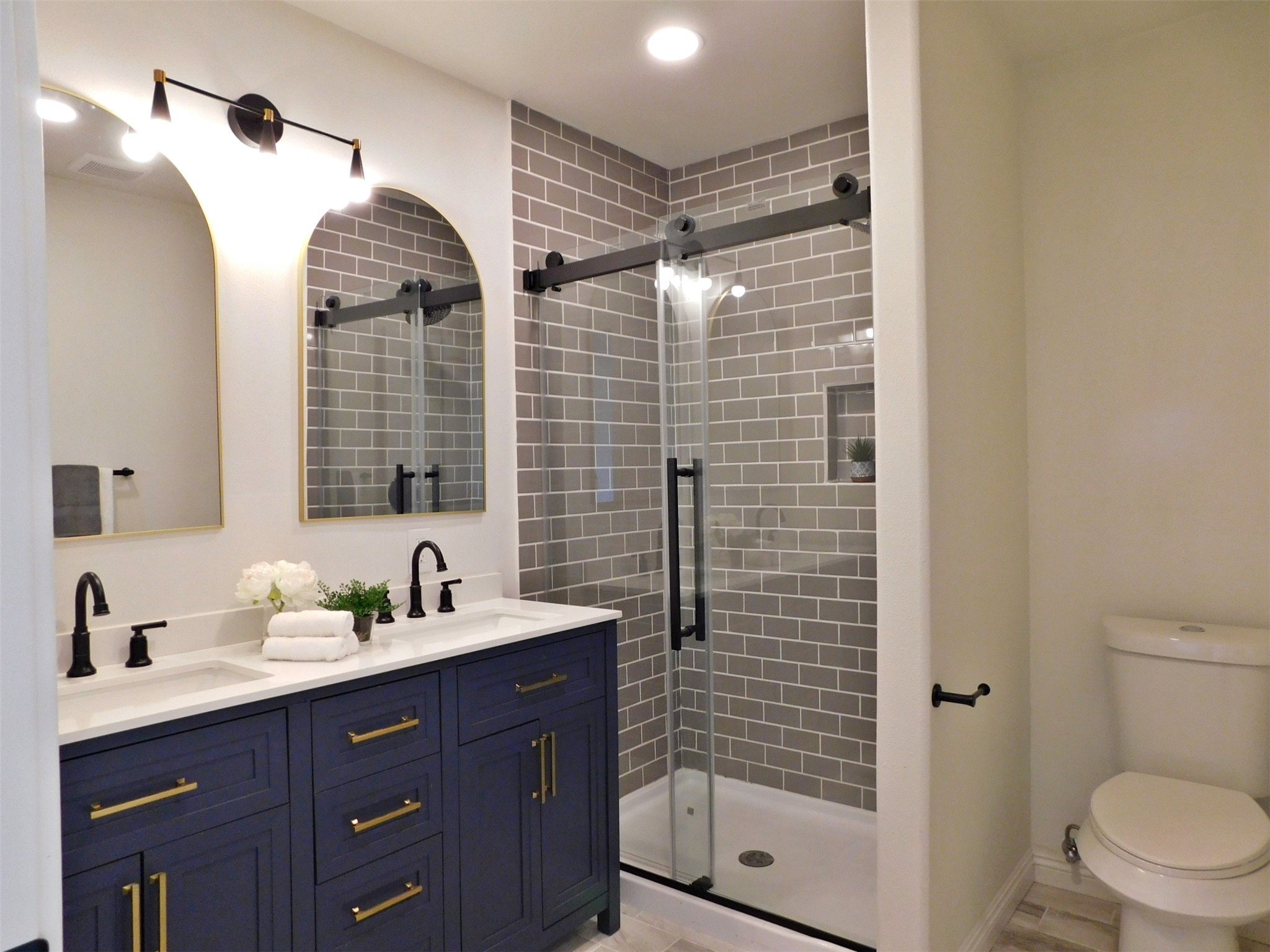 205 East Train Street Ellinger, TX 78938 - Photo 12 of 27 a bathroom with a shower a sink and a mirror
