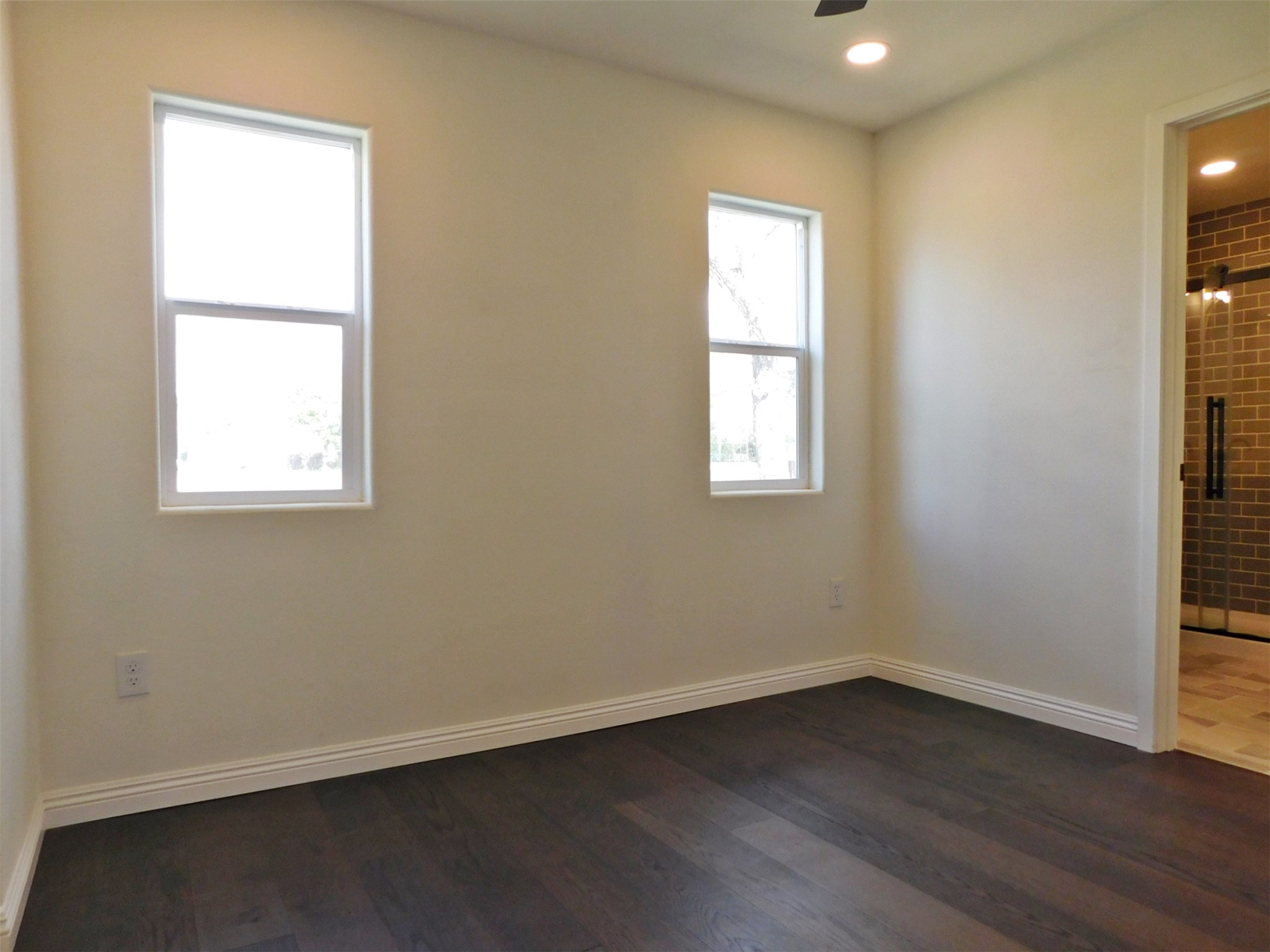 205 East Train Street Ellinger, TX 78938 - Photo 14 of 27 an empty room with wooden floor and windows
