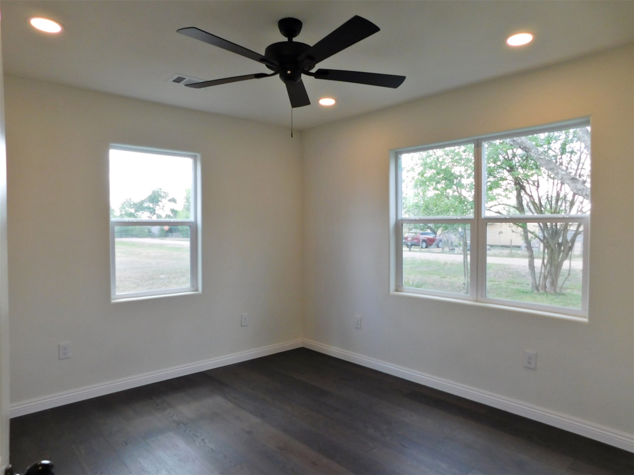 205 East Train Street Ellinger, TX 78938 - Photo 15 of 27 a view of an empty room with wooden floor and a window