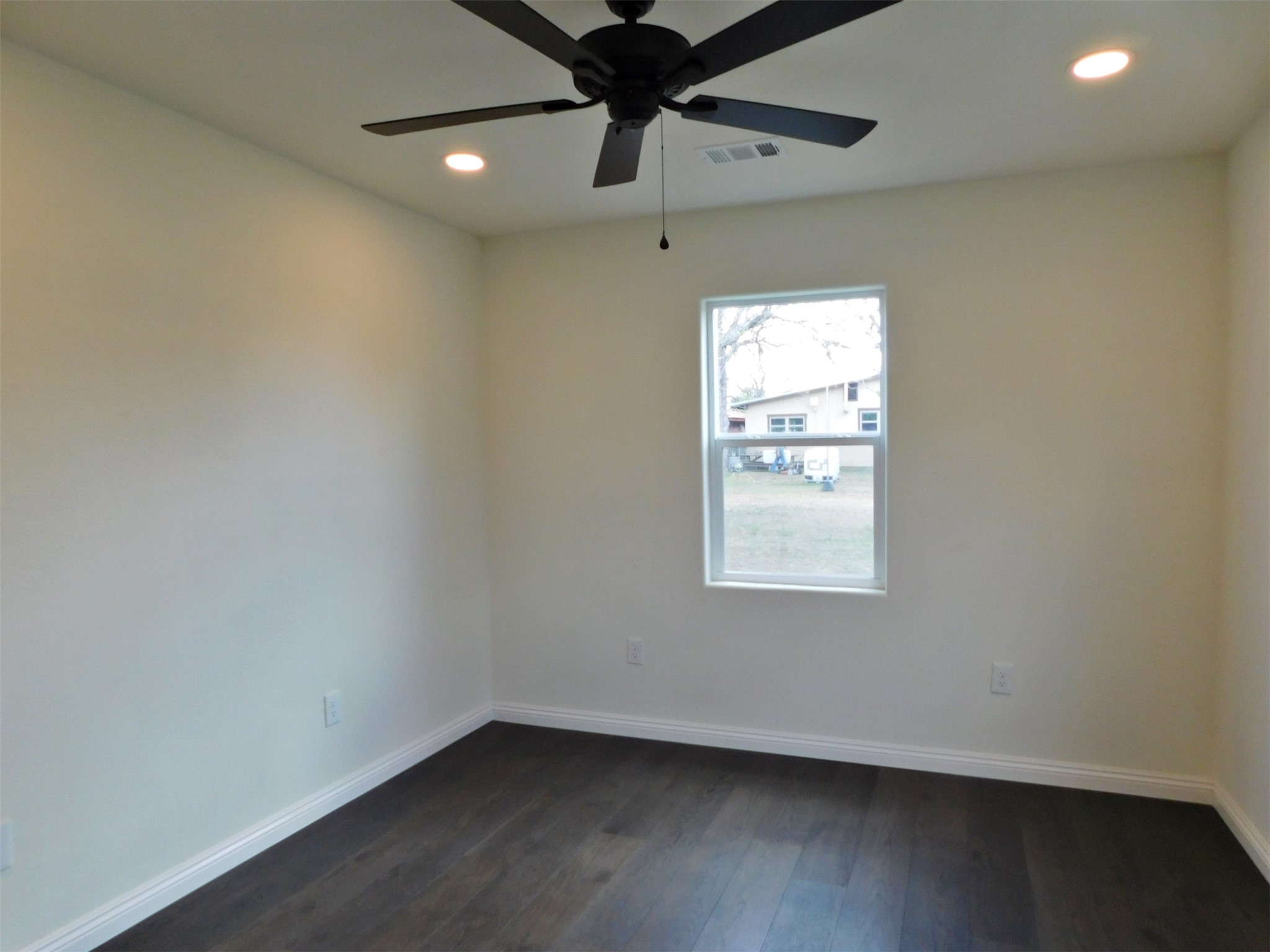 205 East Train Street Ellinger, TX 78938 - Photo 16 of 27 an empty room with a window and a ceiling fan