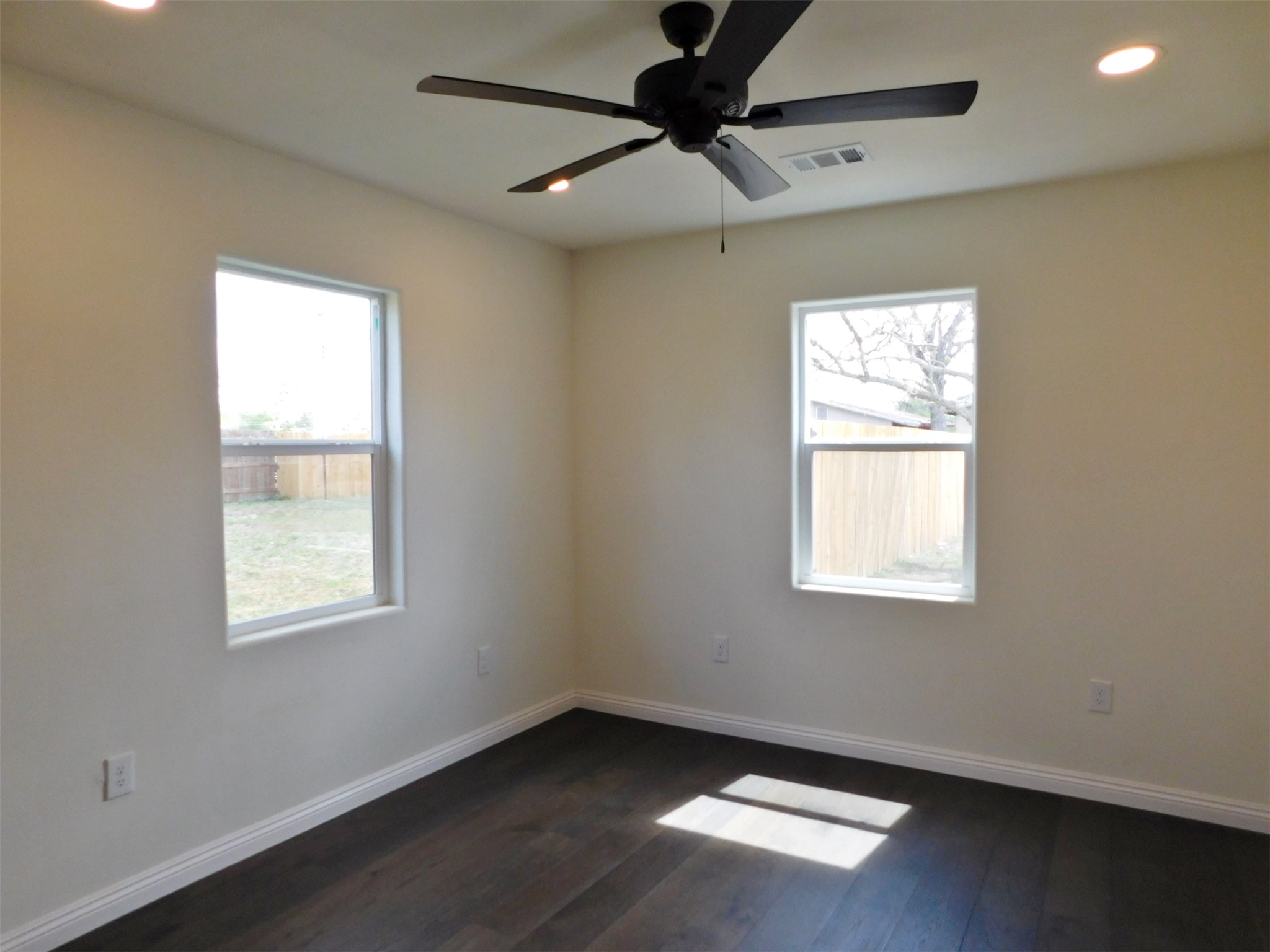 205 East Train Street Ellinger, TX 78938 - Photo 18 of 27 a view of an empty room with wooden floor and a window