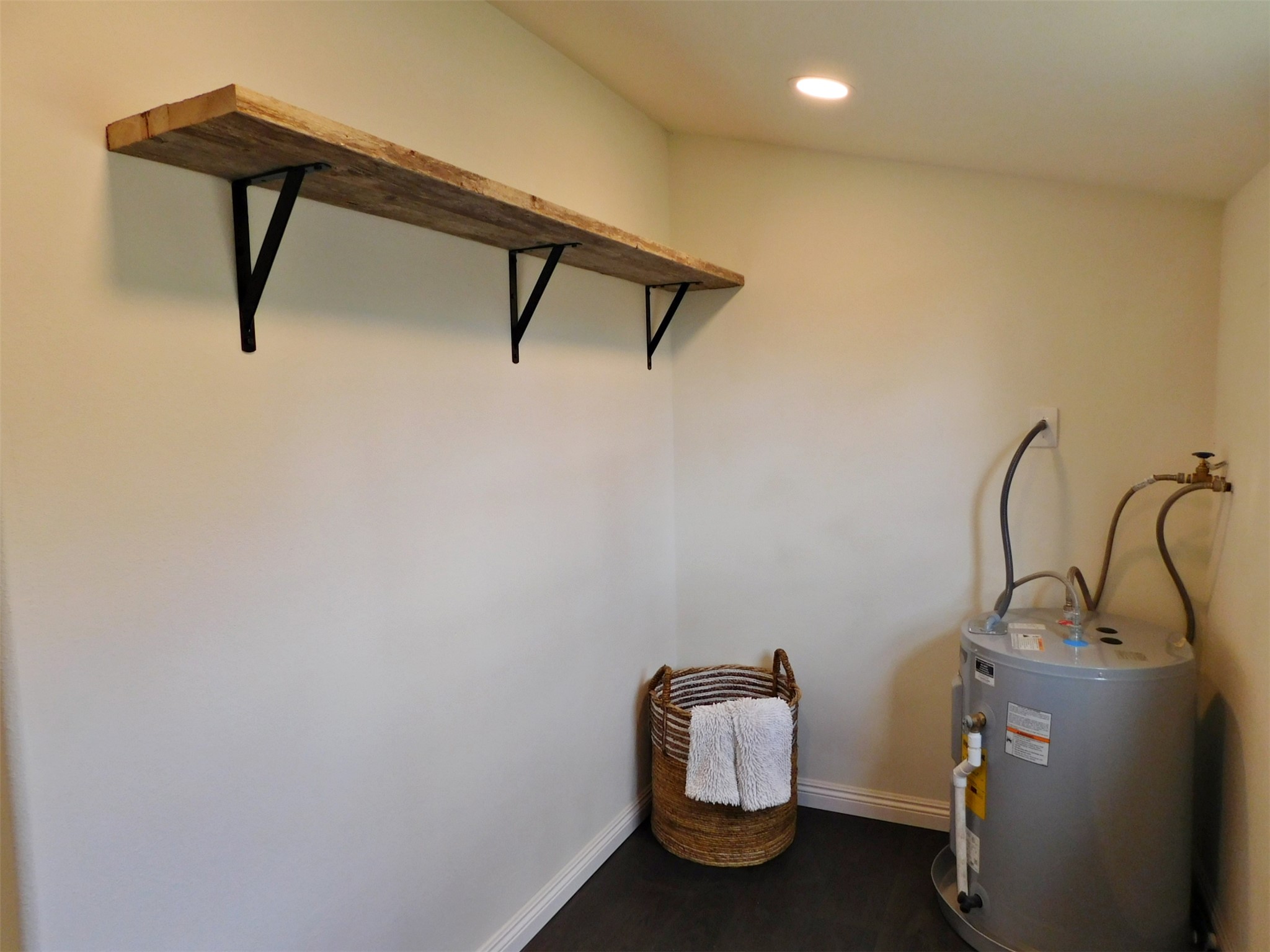 205 East Train Street Ellinger, TX 78938 - Photo 21 of 27 a room with water heater and wooden floor